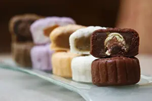 A variety of mooncakes with different fillings are displayed for the camera at a hotel