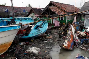 Indonesia Prints: Vessels are washed up next to houses after a tsunami hit in Anyer