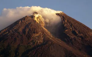 Indonesia Prints: A view of the Mount Merapi volcano emitting smoke is seen during sunrise from Cangkringan