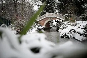France Prints: A view shows a bridge in the Parc Monceau as winter weather bringing snow