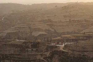 Prints of A village with subterranean houses, that locals refer to as caves, is pictured at sunrise in Lin county, Shanxi province, China March 15, 2018. Picture taken March 15, 2018. REUTERS/Joseph Campbell China Prints: A village with subterranean houses, that locals refer to as caves