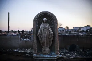 Sandy Prints: A Virgin Mary statue is seen amongst the rubble of a destroyed row of houses after