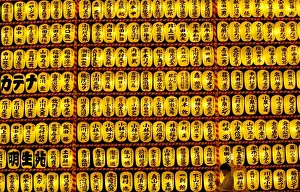 A visitor walks past paper lanterns during the Mitama Festival at the Yasukuni Shrine