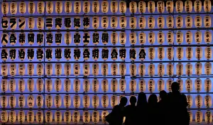 Visitors take pictures in front of paper lanterns during the Autumn Grand Festival