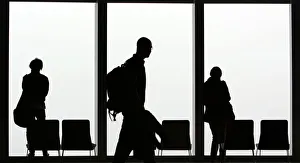 Visitors is silhouetted against a cloudy sky on the observation deck of a skyscraper Visitors is silhouetted against a cloudy sky on the observation deck of a skyscraper
