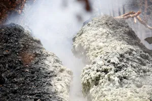 Volcanic gases rise from a fissure in the Leilani Estates subdivision during ongoing Volcanic gases rise from a fissure in the Leilani Estates subdivision during ongoing