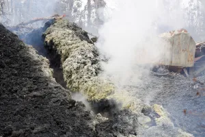Volcanic gases rise from a fissure near the remains of a structure in the Leilani Estates Volcanic gases rise from a fissure near the remains of a structure in the Leilani Estates