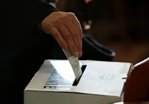 A voter casts her ballot during the presidential election at a polling station in San