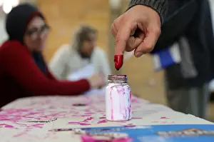 Egypt Prints: A voters finger is marked with ink at a polling station during the second day of