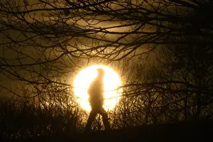 Prints of A walker is silhouetted in front of the setting sun on Primrose Hill in London, Britain, January 24, 2017. REUTERS/Toby Melville TPX IMAGES OF THE DAY ENVIRONMENT Britain Prints: A walker is silhouetted in front of the setting sun on Primrose Hill in London