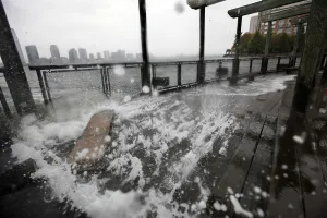 Sandy Prints: Water from Hudson River crashes along the shore in Battery Park in New York