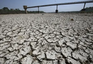 India Prints: A water pump shed is seen in the dried-up portion of the Sabarmati river on a hot day
