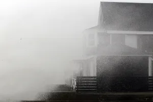 Sandy Prints: A wave crashes onto a house before the arrival of Hurricane Sandy in Scituate