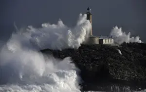 Weather Prints: Waves crash on the lighthouse of La Isla del Mouro in the port town of Santander in