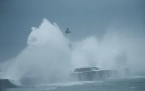 Weather Prints: Waves crash against a lighthouse during a windy day in Boulogne-sur-Mer