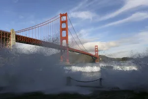 Waves crash against a sea wall in San Francisco Bay beneath the Golden Gate Bridge Waves crash against a sea wall in San Francisco Bay beneath the Golden Gate Bridge