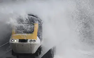 Weather Prints: Waves hit a train during heavy seas and high winds in Dawlish in south west Britain