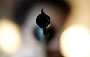 A weapon collector holds a 44 caliber gun in his house in Bordeaux