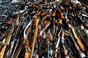 Weapons and drugs are displayed prior to their destruction in a nickel smelting plant