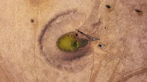 Prints of A windmill and solar panels stand next to a dam in a drought-effected paddock on farmer Scott Coopers property named South Park located east of the town of Gunnedah, in New South Wales, Australia Australia Prints: The Wider Image: Australias drought - the cancer eating away at farms