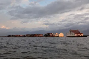 Climate Prints: The Wider Image: Rising seas threaten early end for sinking village in Philippines