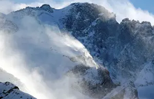 France Prints: Wind blows snow off the top of a mountain in Saint-Pancrace as winter weather bringing