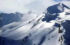 France Prints: Wind blows snow off the top of a mountain in Saint-Pancrace as winter weather bringing