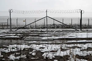 Election Prints: A wire fence is seen next to the village of Asotthalom