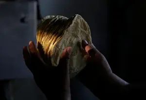 Mexico Prints: Woman holds freshly made corn tortillas at a tortilla factory in Mexico City