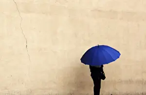 A woman holds an umbrella during a rainy day in Queens borough of New York