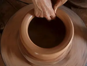Woman makes a clay pot at a factory at Phu Lang pottery village in Bac Ninh province