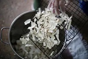 : A woman manipulates dehydrated yucca at the Quinta Carmelita store