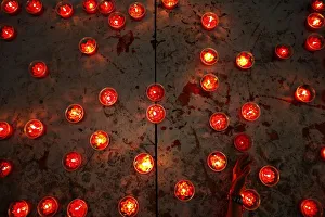 Woman places candle at a temple ahead of the Chinese Lunar New Year celebrations in