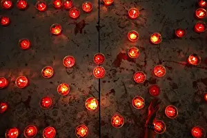 Woman places candle at a temple ahead of the Chinese Lunar New Year celebrations in