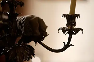 Precious Prints: A woman polishes an antique silver candelabra at her home in Valletta