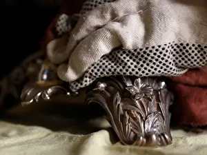 Precious Prints: A woman polishes an antique silver candelabra at her home in Valletta