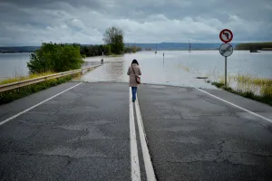 A woman stands on a road flooded by waters from the River Ebro A woman stands on a road flooded by waters from the River Ebro