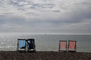 Prints of A woman sunbathes in a deckchair by the sea on a sunny day on Brighton Beach in southern England, Britain September 12, 2016. REUTERS/Stefan Wermuth TPX IMAGES OF THE DAY Britain Prints: A woman sunbathes in a deckchair by the sea on a sunny day on Brighton Beach in southern