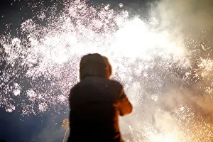 Southkorea Prints: A woman takes photographs of fireworks during a celebration ahead of Jeongwol Daeboreum