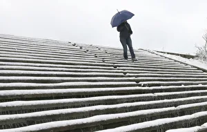 A woman walks downstairs after a heavy snowfall in Divnogorsk