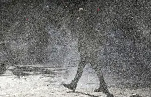 Images Dated 2014 January: A woman walks through a gust of blowing snow in frigid cold temperatures during winter in