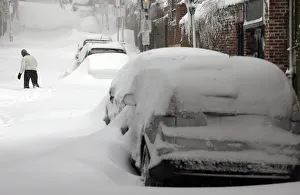 Weather Prints: A woman walks up a snow filled street in Boston