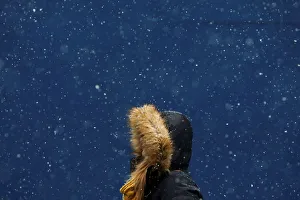 A woman walks in the snow at Times Square in New York
