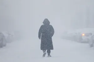 Images Dated 4th January 2018: A woman walks down the street during a blizzard in Long Beach