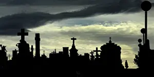 Religion Prints: A woman walks along the tombs at the municipal cemetery of San Salvador in Oviedo