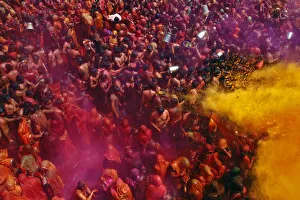 Celebration Prints: Women cover themselves as men pour coloured water on them during Huranga at Dauji
