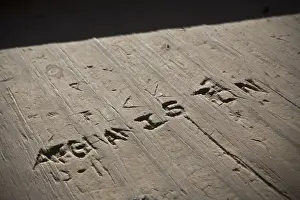 The word Afghanistan is carved into wood in a guard tower at Command Outpost AJK