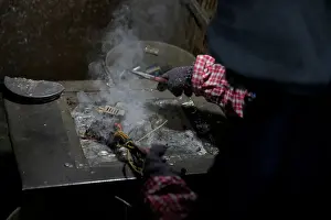A worker dismantles electronic waste at the government-sponsored recycling park in