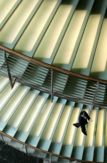 A worker at a hotel walks down a staircase in Tokyo