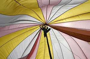 Worker ties a rope while assembling a tent in preparation for a visit by former Philippine